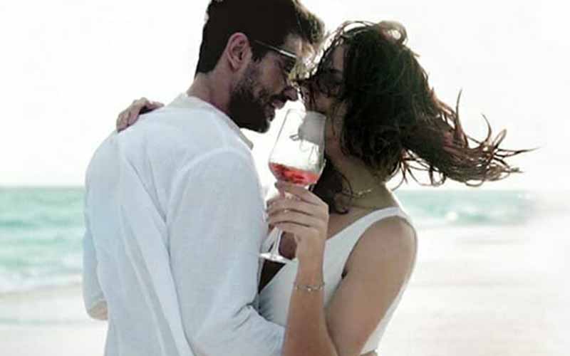 A romantic moment between a couple on the beach at The Nautilus Maldives