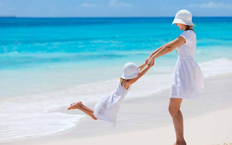 A mother and daughter having family beach fun at The Nautilus Maldives