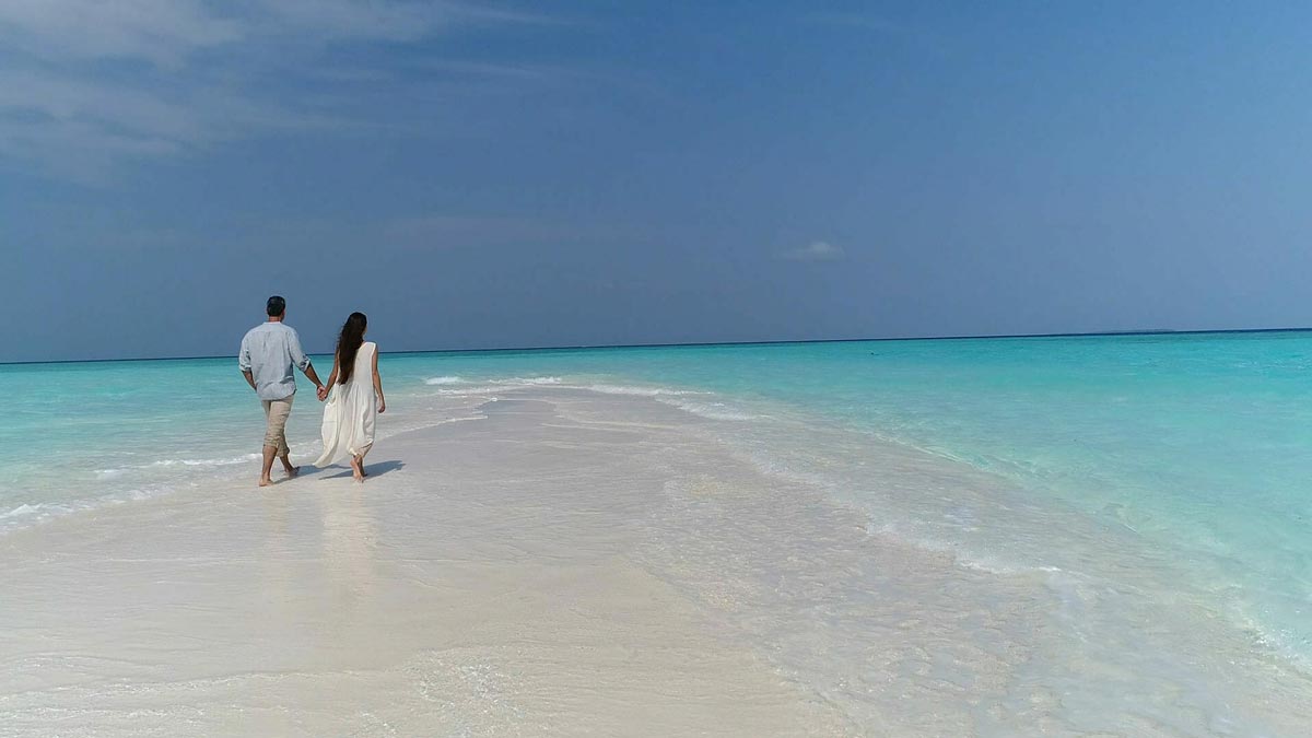 Couple Walking on the Beach in Maldives 