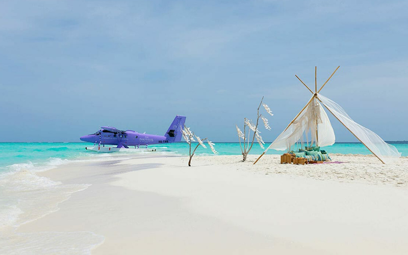 The Nautilus private seaplane docked on a private beach