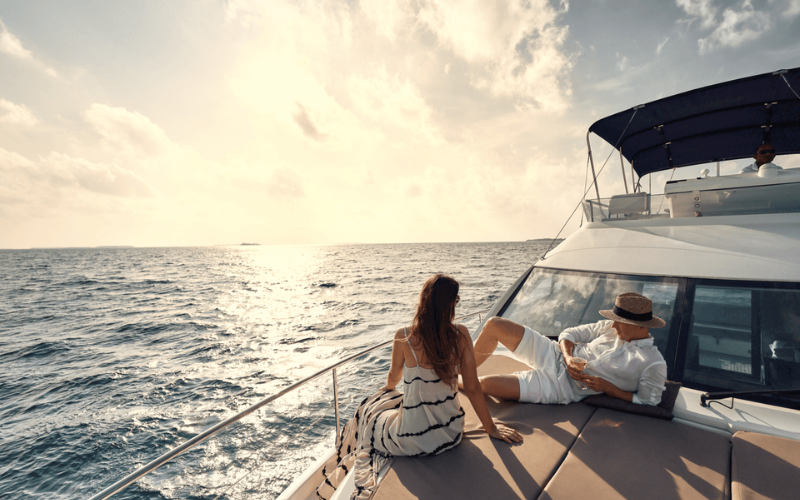 A couple lounging on a luxury yacht, on a cruise excursion from The Nautilus Maldives