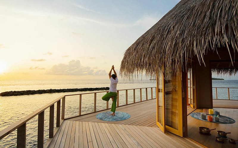 Man doing Yoga at the Yoga Pavilion at sunrise