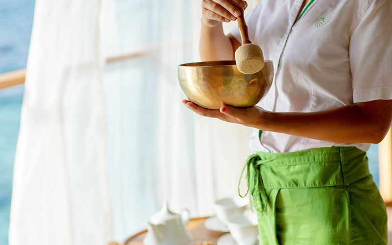 Spa therapist using a singing bowl