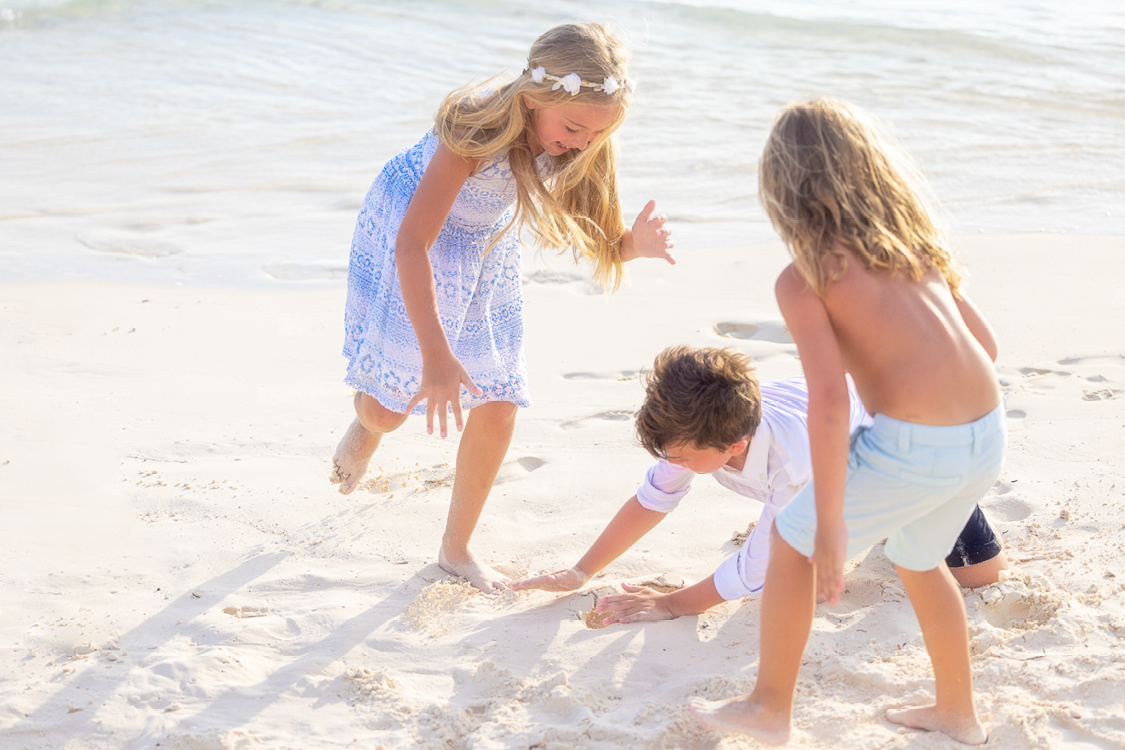 Three young children playing on the sand at The Nautilus Maldives