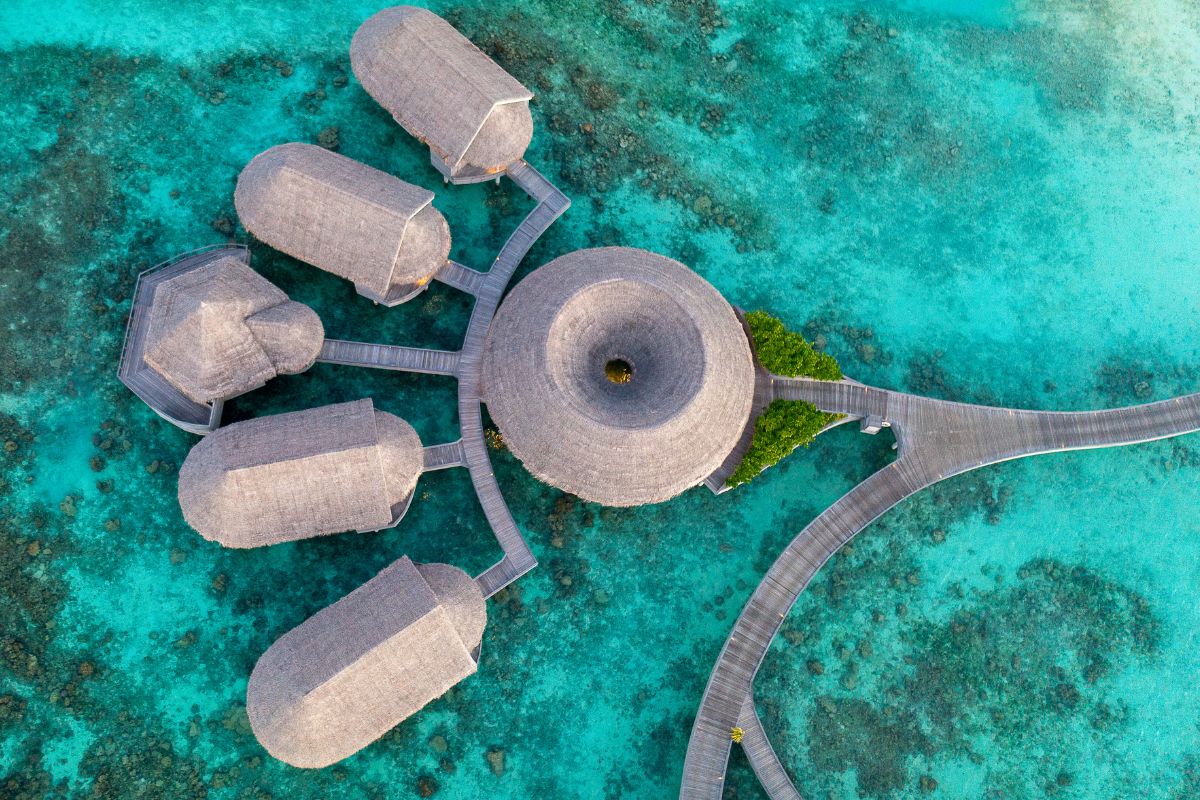 Top down aerial view of the overwater treatment rooms and yoga pavillion at Solasta Spa