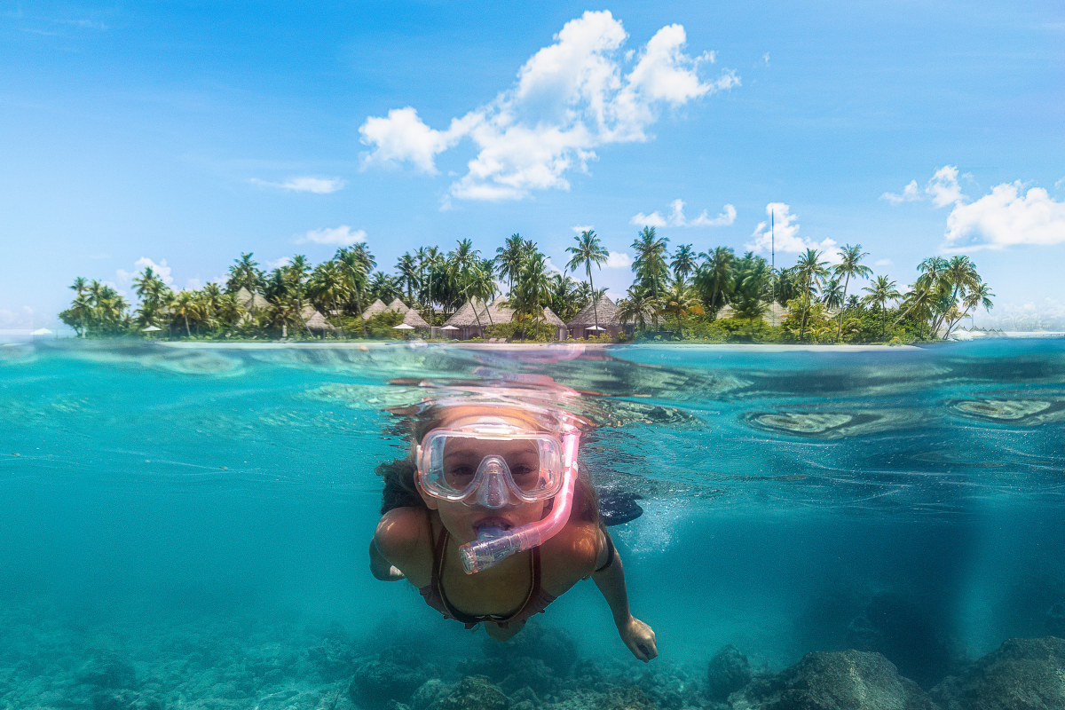 A young girl snorkels at The Nautilus Maldives house reef