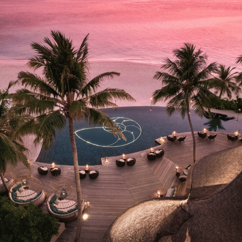 Aerial View of Naiboli Pool Bar at the Nautilus Maldives during sunset