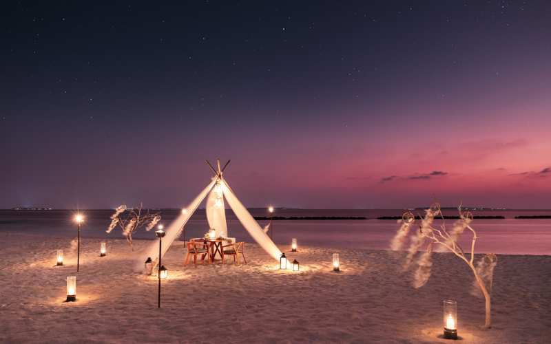 Private dining setup on the beach at The Nautilus Maldives
