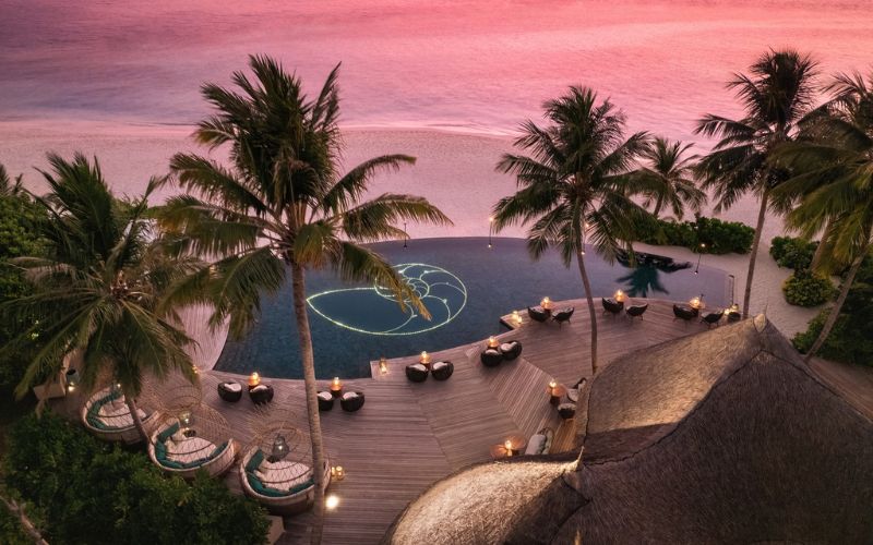 Aerial View of Naiboli Pool Bar at the Nautilus Maldives during sunset