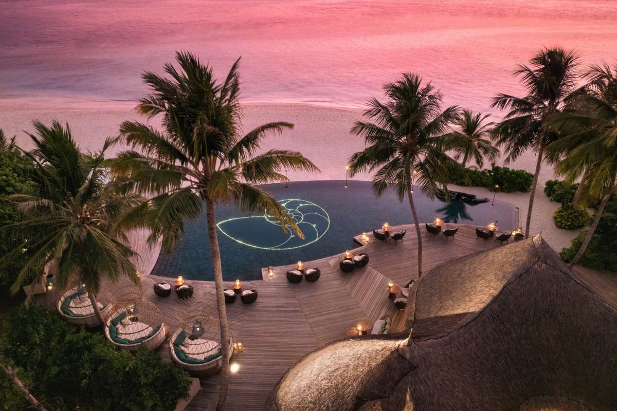 Aerial View of Naiboli Pool Bar at the Nautilus Maldives during sunset