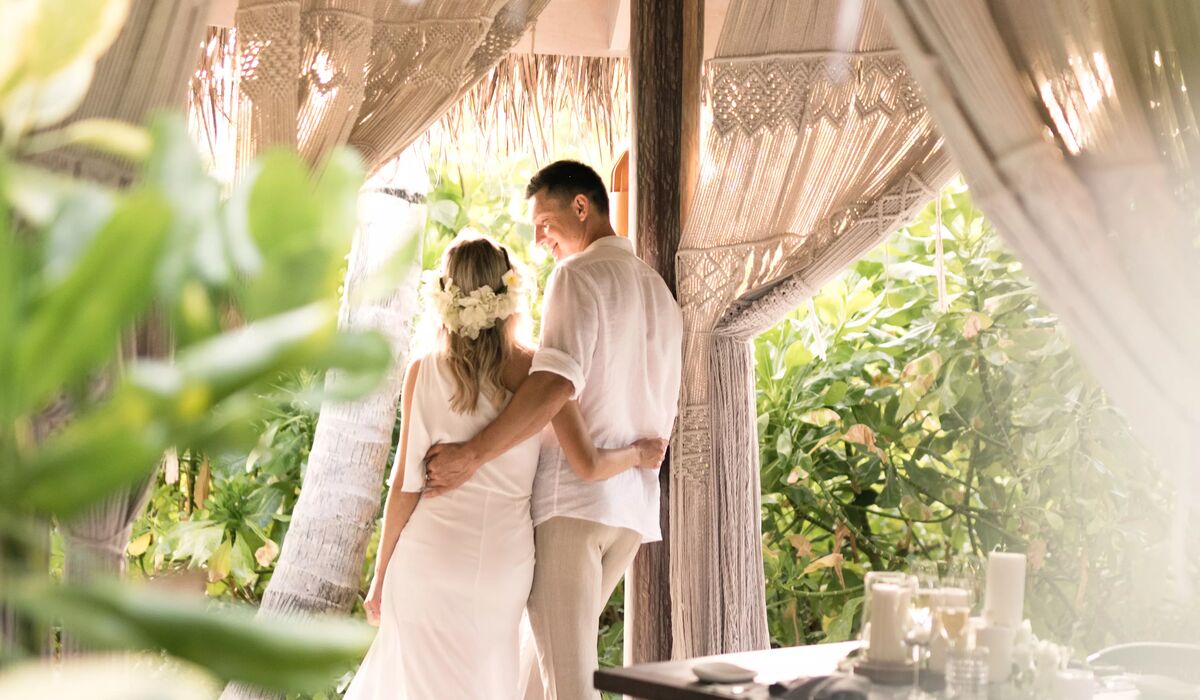 A bride and groom at Ocaso, the beachside grill restaurant at The Nautilus Maldives