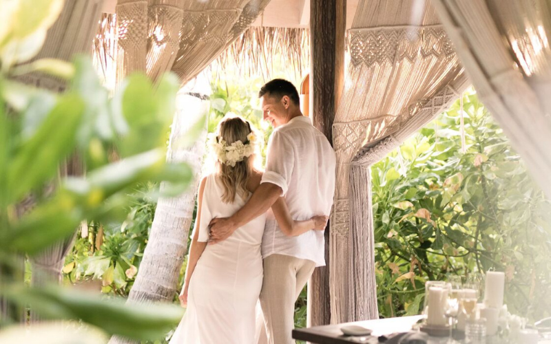 A bride and groom at Ocaso, the beachside grill restaurant at The Nautilus Maldives