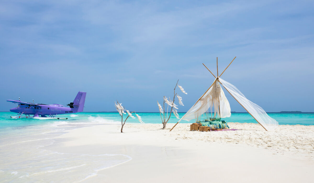 Bohemian setup at sandbank with The Nautilus Maldives seaplane docked