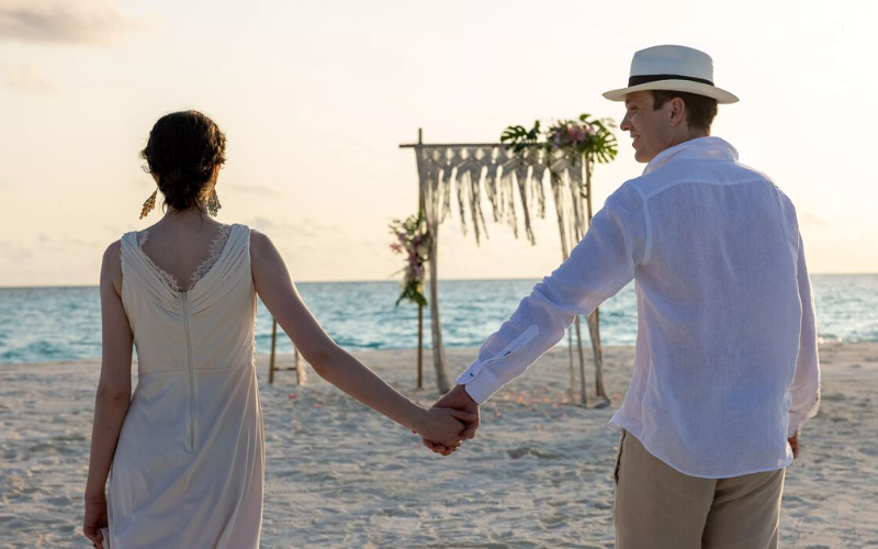 Couple walking to their wedding arch at The Nautilus Maldives